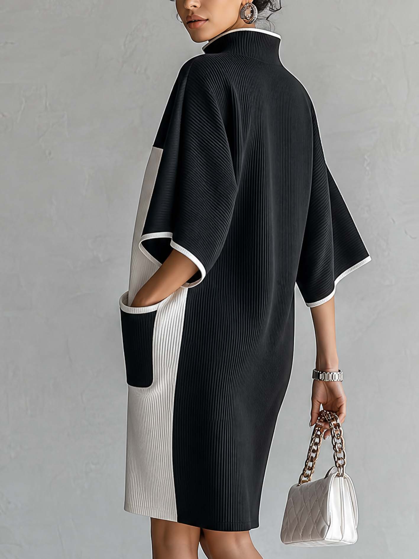 Zwart-witte midi-jurk in colorblock met vleermuismouwen